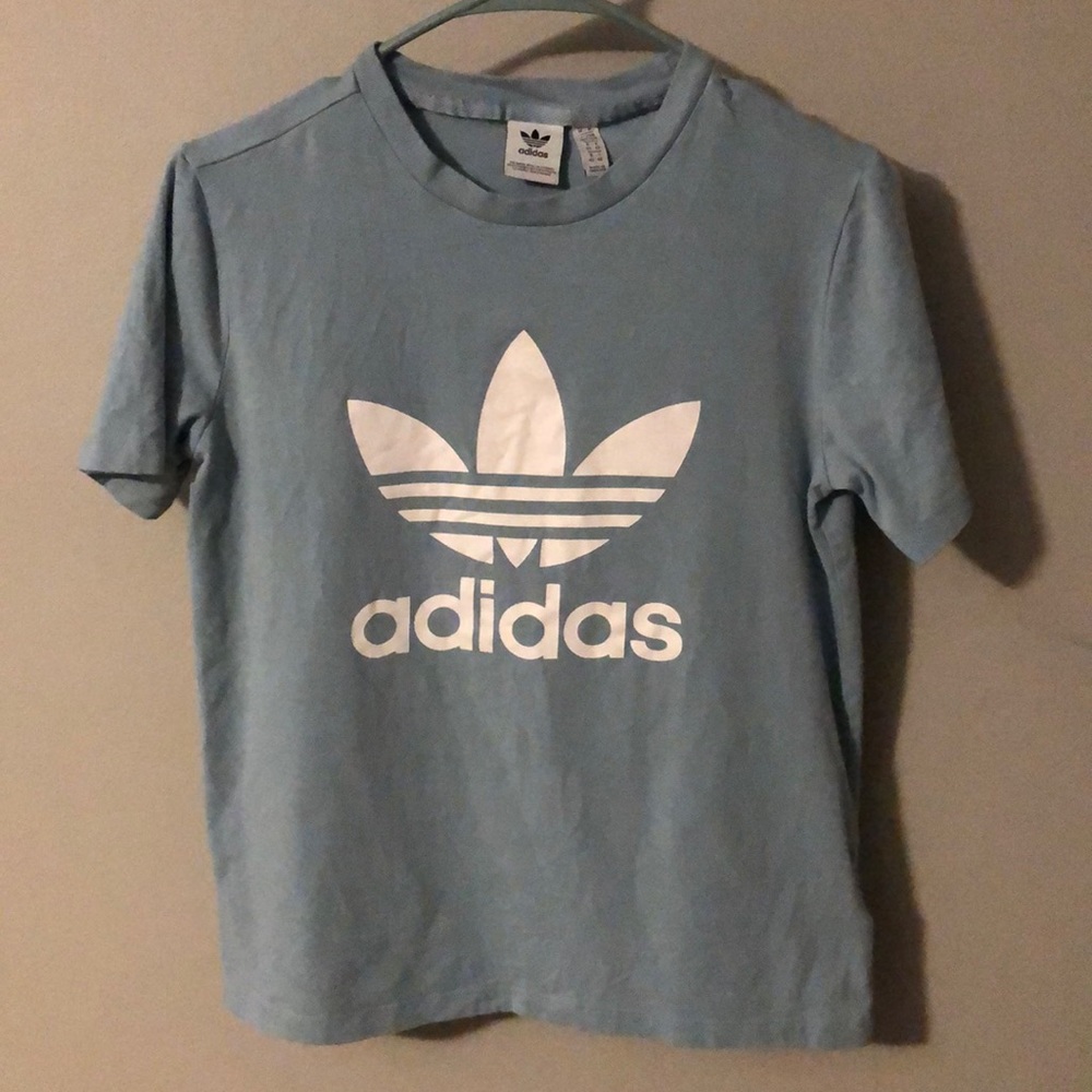 Light blue adidas shirt.